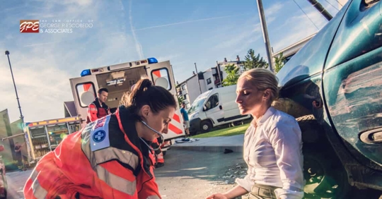 Female emergency medical response worker taking care of a female auto accident victim