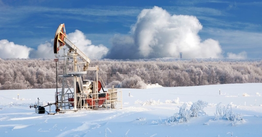 oil derrick in a snow covered field