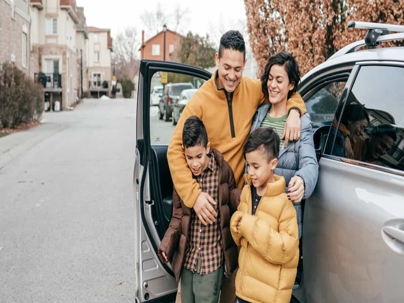 Happy Family Outside Car in Fall